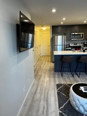 a kitchen with wooden floors and stainless steel appliances at The Waterfront cozy 1 bd suite in Rockland Park, Tuscany NW in Calgary