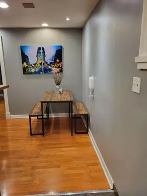 a room with a table and a painting on the wall at Garden suite on Trinity St in Vancouver