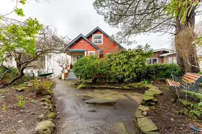 a house with a stone path in front of it at Garden suite on Trinity St in Vancouver
