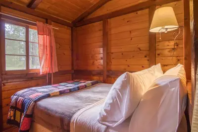 a bedroom with a bed in a log cabin at Timbers Resort in Fairmont Hot Springs