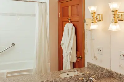 a bathroom with a sink and a shower at The Grand Hotel Nanaimo in Nanaimo