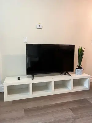a flat screen tv sitting on top of a white entertainment center at Private suite 1 bed 1 bath 15 mins YVR and downtown \u8212\u9002\u5b89\u9759 in Vancouver