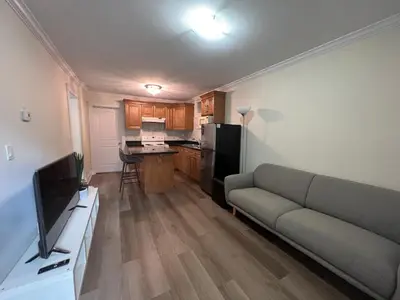 a living room with a couch and a kitchen at Private suite 1 bed 1 bath 15 mins YVR and downtown \u8212\u9002\u5b89\u9759 in Vancouver