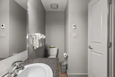 a bathroom with a sink and a toilet in it at Rocky Mountain Getaway with Outdoor Heated Pool, 3 Hot Tubs, Gym, BBQ, Garage & 24 hour Reception near Banff in Canmore