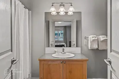 a bathroom with a sink and a mirror at Rocky Mountain Getaway with Outdoor Heated Pool, 3 Hot Tubs, Gym, BBQ, Garage & 24 hour Reception near Banff in Canmore