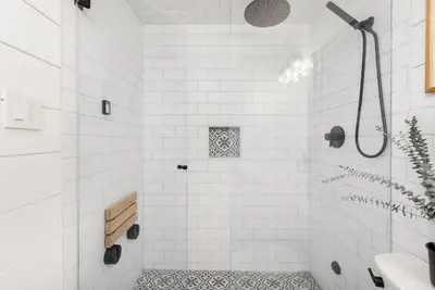 a white bathroom with a shower and a sink at Powderview 12 by Whistler Premier in Whistler