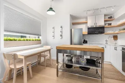 a kitchen with a table and a counter top at Powderview 12 by Whistler Premier in Whistler