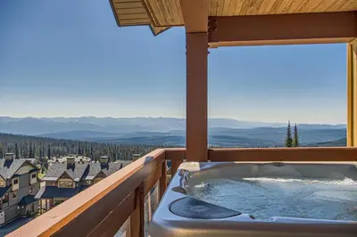 a hot tub on a balcony with a view at The Crescent 201 by Okanagan Premier in Big White