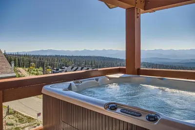 a hot tub on a balcony with a view at The Crescent 201 by Okanagan Premier in Big White