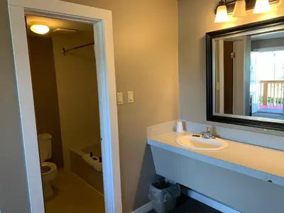 a bathroom with a sink and a mirror and a toilet at Rondo Motel in Golden