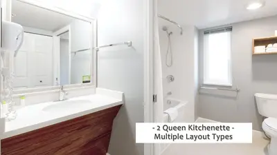 a white bathroom with a sink and a toilet at Gibsons Garden Hotel in Gibsons