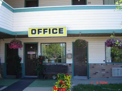 a office sign on the front of a building at Hoo-Doo Motel in Drumheller