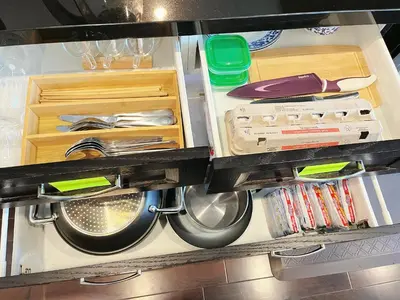 a kitchen with a dishwasher and cabinets and a sink at Derbyshire House in Coquitlam