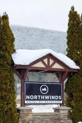a sign with snow on top of it at Northwinds Hotel Revelstoke in Revelstoke