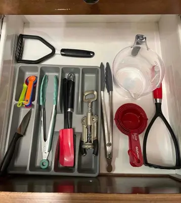 a drawer filled with kitchen utensils on a counter at Resort Style Living with Private Lawn and Patio in Kelowna