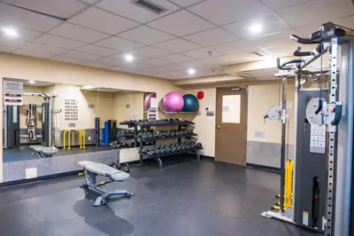 a room with a gym with exercise equipment at Resort Style Living with Private Lawn and Patio in Kelowna