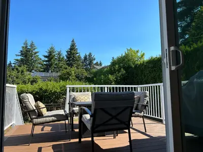 a patio with chairs and a table on a deck at Blue Sea And Clear Sky B&B LICENCE NUMBER 18952 in Victoria