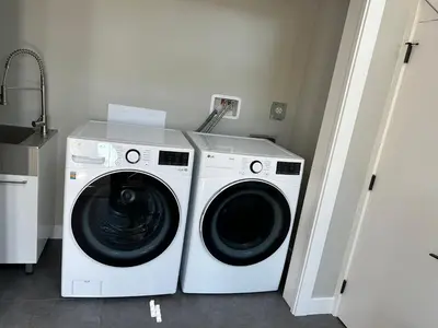 a white washer and dryer in a laundry room at Blue Sea And Clear Sky B&B LICENCE NUMBER 18952 in Victoria