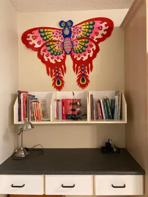 a red butterfly kite is hanging on a wall at Red Robe B&B in Nanaimo