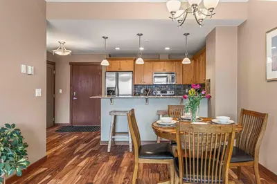 a kitchen and dining room with a table and chairs at Best Views of Canmore - 2Bed 2Bath in Canmore