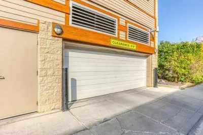 a garage with two doors on a building at Best Views of Canmore - 2Bed 2Bath in Canmore