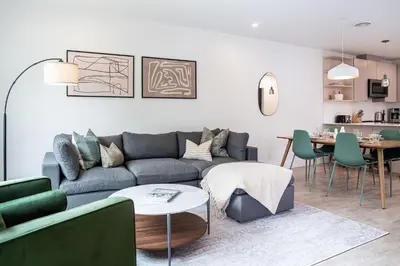 a living room with a couch and a table at Serenity Now by Revelstoke Vacations in Revelstoke