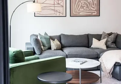 a living room with a couch and a table at Serenity Now by Revelstoke Vacations in Revelstoke