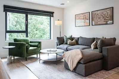 a living room with a couch and two chairs at Serenity Now by Revelstoke Vacations in Revelstoke