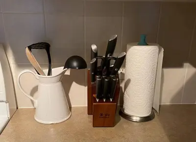 a counter with a knife block and a container of utensils at Lux 2BR 5BD Suite Mountain view! in Canmore