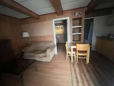 a living room with a couch and a table at Caravan Motel in Fort Saint John