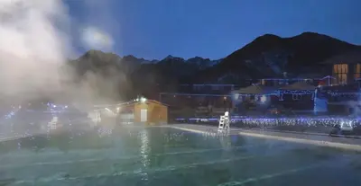 a fountain in the middle of a city at night at Mountain View Vacation Villa Main Floor Unit, No Stairs in Fairmont Hot Springs