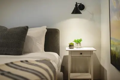 a bedroom with a bed and a side table with plants at 3BR in Snowberry, King Bed, Wood Burning Fireplace, Large Kitchen, Near Gondola in Whistler