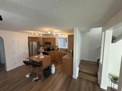 a kitchen with a island in the middle of a room at Spacious & Private Retreat near West Edmonton Mall in Edmonton