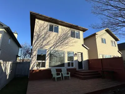 a house with two chairs sitting on a deck at Spacious & Private Retreat near West Edmonton Mall in Edmonton