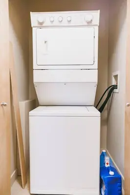 a white stove top oven sitting in a kitchen at Lux 2BR/3BD Suite/Mountain View! in Canmore