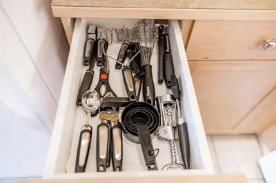 a drawer filled with cooking utensils in a cabinet at Lux 2BR/3BD Suite/Mountain View! in Canmore