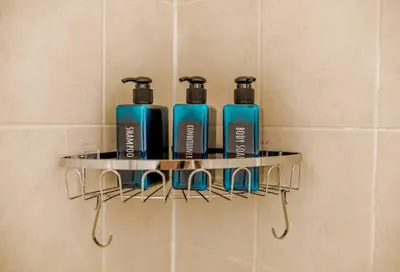 a rack with four bottles on a wall in a bathroom at Lux 2BR/3BD Suite/Mountain View! in Canmore