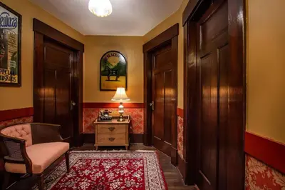 a hallway with a chair and a table with a lamp at The Hazelhouse in Chilliwack