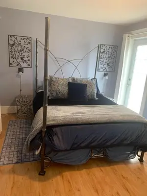a bedroom with a bed with a metal frame at Sweetest Suite Downtown in Salmon Arm