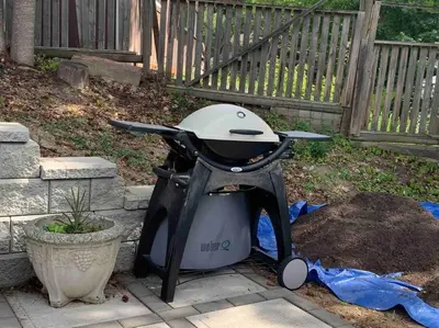 a grill sitting on the ground in a yard at Sweetest Suite Downtown in Salmon Arm