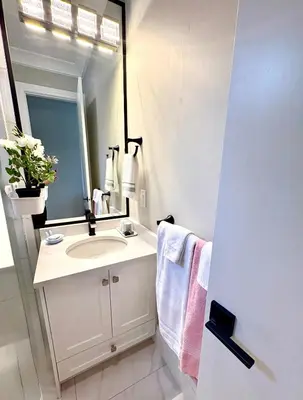 a white bathroom with a sink and a mirror at Home sweet home in Richmond