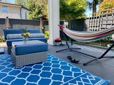 a hammock on a patio with a couch and a hammock at Home sweet home in Richmond