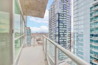 an apartment balcony with a view of a city at Luxury 2BR Condo - King Bed - Stunning City Views in Calgary
