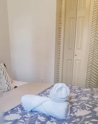 a pile of towels sitting on top of a bed at Bright 3 bed 3 bath House in Radium Hot Springs in Radium Hot Springs