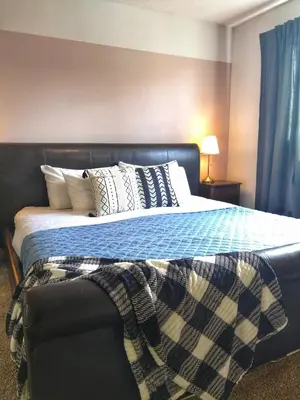 a bedroom with a bed with a blanket on it at Bright 3 bed 3 bath House in Radium Hot Springs in Radium Hot Springs