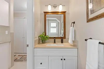 a bathroom with a sink and a mirror at Grand English Style Home in Chilliwack