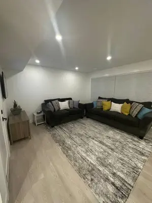 a living room with a couch and a rug at The Royal Bay Escape: Cozy 2 bedrooms garden suite in Colwood