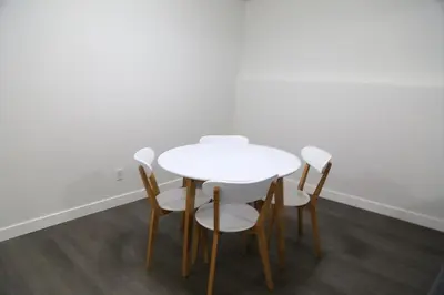 a white table and chairs in a room at Cozy 3 beds Suite Near Calgary Airport Sleeps 6 in Calgary