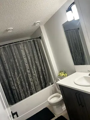 a bathroom with a toilet and a sink at Praise bethel -Homely walkout legal basement in YYC in Calgary