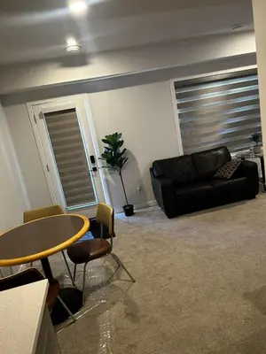 a living room with a table and a couch at Praise bethel -Homely walkout legal basement in YYC in Calgary